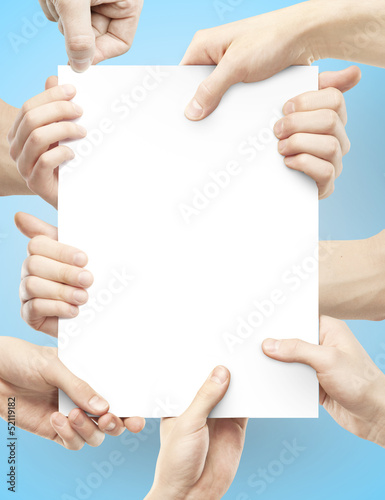 Photo: many hands holding poster many hands holding poster