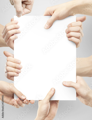 Photo: many hands holding paper many hands holding paper