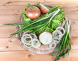 Composition with herbs and onions on wooden table