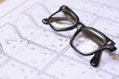 Architecture blueprints and glasses
