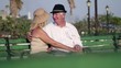 Video: Elderly man and woman talking, kissing in city park Elderly man and woman talking, kissing in city park