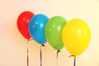 Four bright balloons on light background