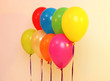 Many bright balloons on orange background