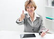 Businesswoman showing thumbs up sign