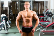 Photo: Bodybuilder posing in Gym Bodybuilder posing in Gym