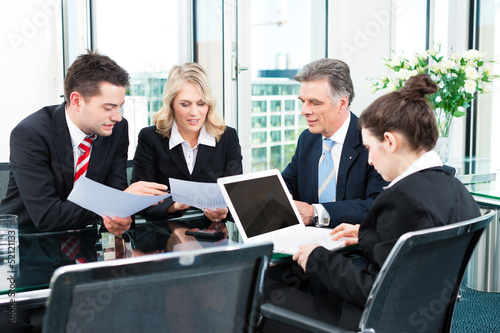 Photo: Business people - meeting in an office Business people - meeting in an office