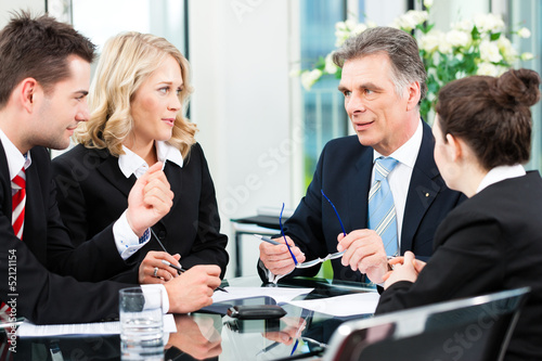 Photo: Business people - meeting in an office Business people - meeting in an office