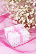 Flowers and gift box on pink background