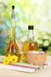 Useful pumpkin seed oil on wooden table on natural background