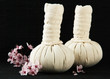 Herbal compress balls for spa treatment on bamboo background