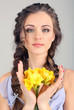 Young woman with beautiful hairstyle and flowers,