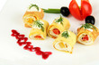 Photo: Egg rolls with cheese cream and paprika,on plate, isolated Egg rolls with cheese cream and paprika,on plate, isolated