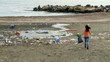 Beautiful woman cleaning dirt and dump on beach