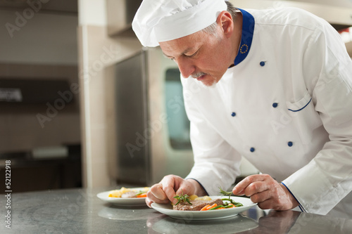 Photo: Chef garnishing a dish Chef garnishing a dish