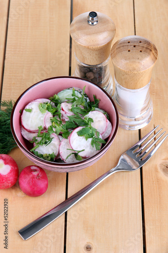Photo: Vitamin vegetable salad in bowl on wooden table close-up Vitamin vegetable salad in bowl on wooden table close-up