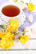 Beautiful composition with cup of tea and marshmallow
