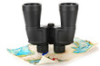 Black modern binoculars with map of adventure isolated on white