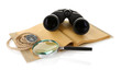 Black modern binoculars with old notebook isolated on white