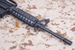 assault rifle with cartridges on us marines camouflage uniform