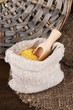 Grains in sack on wooden background