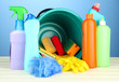 Cleaning items in bucket on  color background