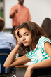 Bored Female Teenage Pupil In Classroom