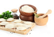 Raw dumplings and ingredients on wooden desk, isolated on white