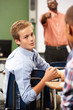 Foto: Two Male Pupils Talking In Class Two Male Pupils Talking In Class
