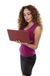 Woman standing with a laptop computer in her hands.