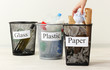 Three buckets of assorted debris on room background