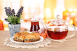 Sweet baklava on plate with tea on table in room