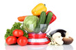 Fresh vegetables in scales isolated on white