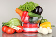 Fresh vegetables in scales on gray background