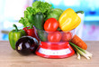 Fresh vegetables in scales on table in kitchen