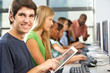 Boy Using Digital Tablet In Computer Class