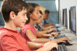 Elementary Students Working At Computers In Classroom