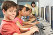 Elementary Students Working At Computers In Classroom