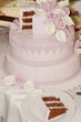 Pink fancy wedding cake decorated with flowers