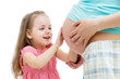 kid girl touches pregnant mother's belly isolated