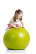 Kid girl having fun with  gymnastic ball isolated