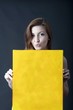 Foto: young woman with canvas panel for advertising and text young woman with canvas panel for advertising and text