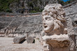 Stone mask and ancient amphitheater, Myra (Turkey )