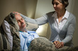 Photo: Sick lying senior man and caring wife Sick lying senior man and caring wife