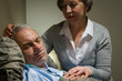 Photo: Caring nurse with sleeping senior male patient Caring nurse with sleeping senior male patient