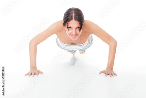 Photo: Young woman doing push ups exercise Young woman doing push ups exercise