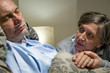 Anxious old woman taking care of husband