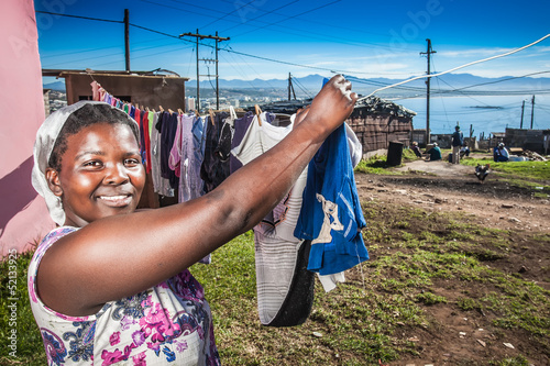 Photo: Woman busy with her family's laundry Woman busy with her family's laundry