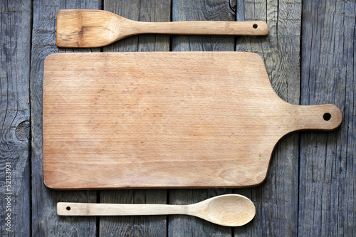 Photo: Empty vintage cutting board on planks food background concept Empty vintage cutting board on planks food background concept