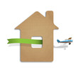 House cut out of cardboard with airplane