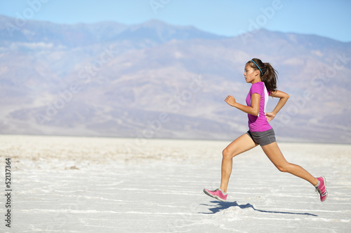 Photo: Runner woman running and sprinting on trail run Runner woman running and sprinting on trail run